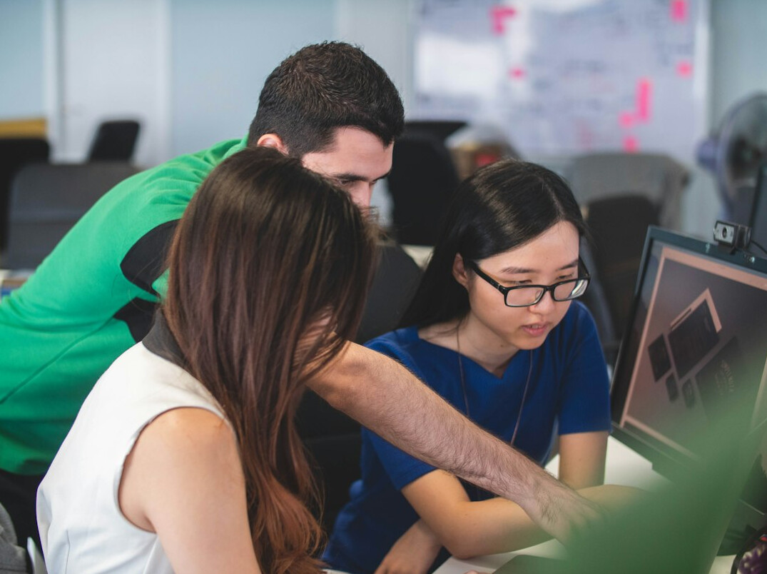 group of students coding together
