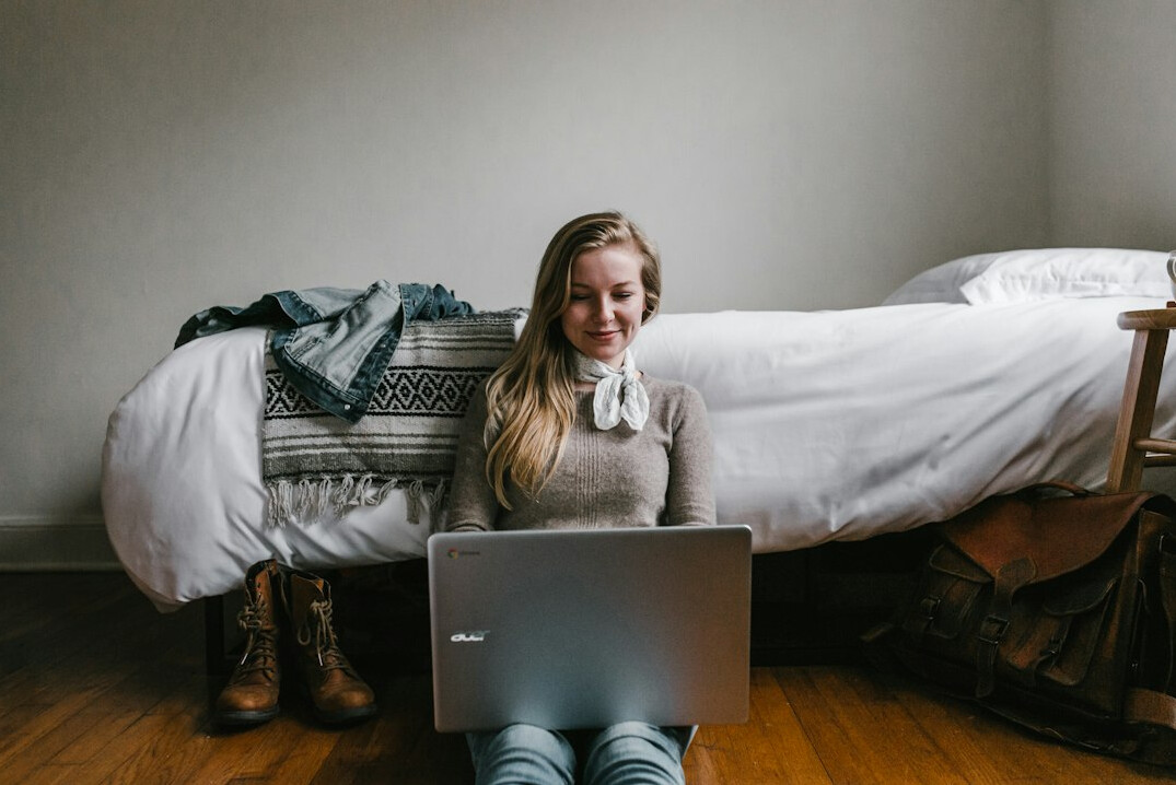 person smiling while coding at home